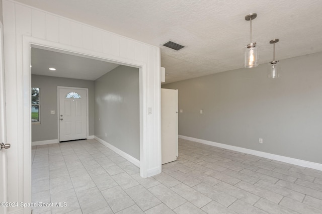 entryway with a textured ceiling