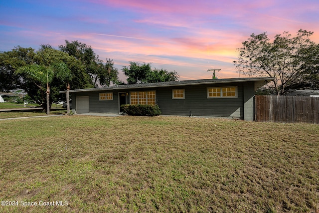 ranch-style home featuring a lawn