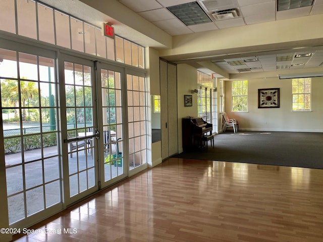 interior space featuring hardwood / wood-style flooring and a paneled ceiling