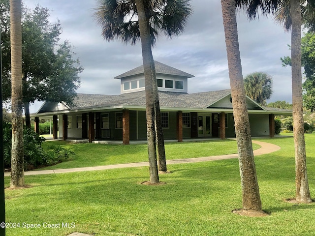 rear view of property with a lawn and covered porch