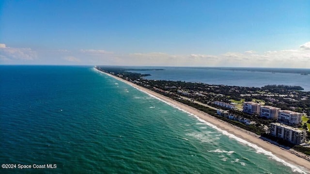 birds eye view of property with a water view and a beach view