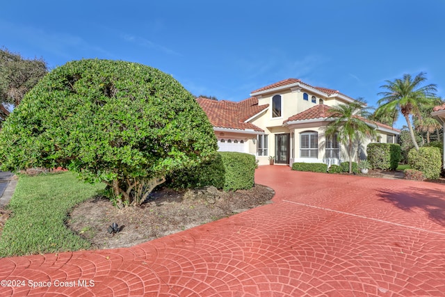 mediterranean / spanish-style house with a garage