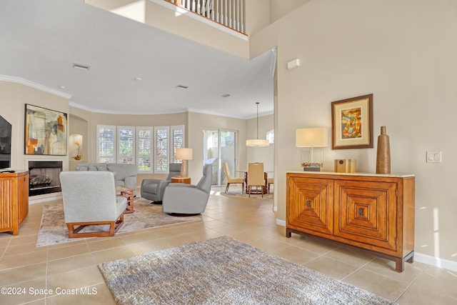 living room with light tile patterned flooring and crown molding