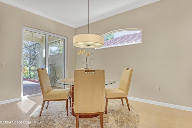 dining room with ornamental molding and light tile patterned floors