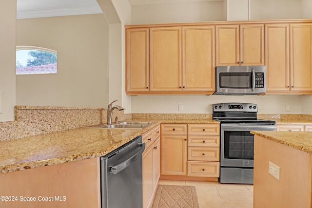 kitchen with light brown cabinets, appliances with stainless steel finishes, sink, and crown molding