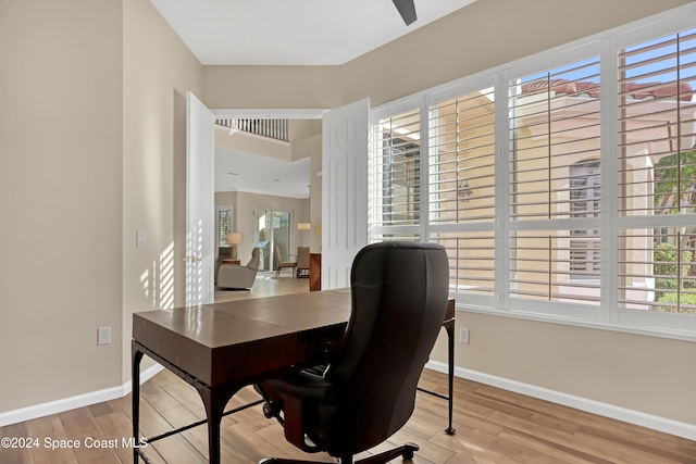 office space featuring ceiling fan and light hardwood / wood-style floors