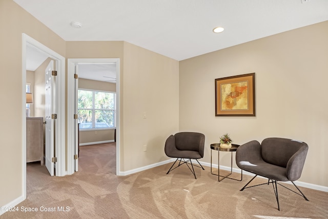 sitting room featuring light colored carpet