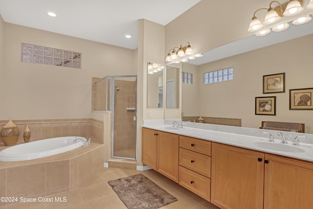 bathroom with independent shower and bath, vanity, and tile patterned floors