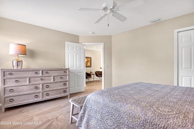 bedroom featuring light colored carpet and ceiling fan