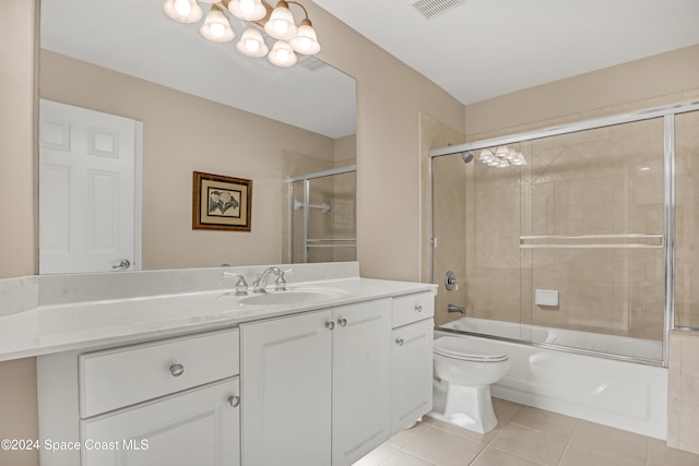 full bathroom featuring vanity, enclosed tub / shower combo, tile patterned flooring, and toilet