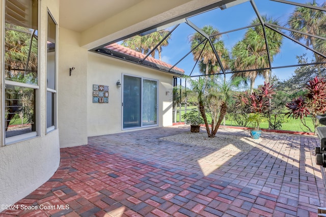 view of patio featuring a lanai