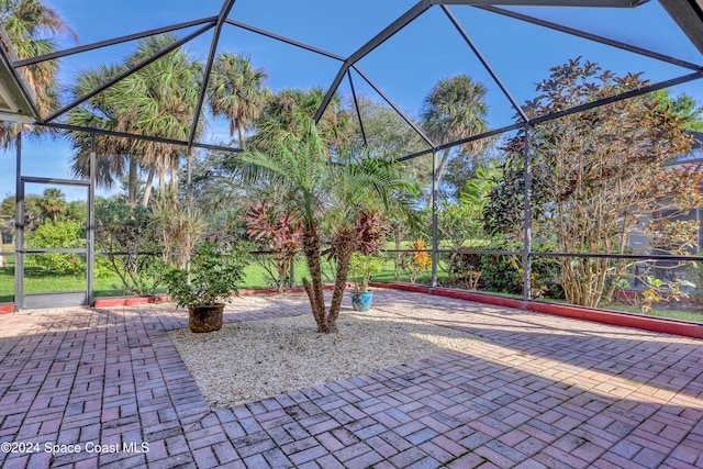 view of patio with glass enclosure