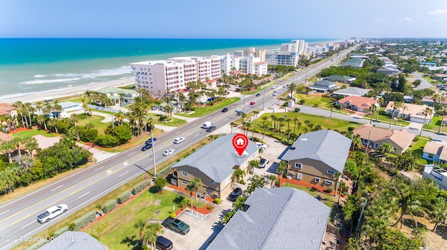 drone / aerial view featuring a water view and a beach view