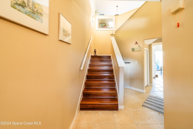 stairway featuring tile patterned floors