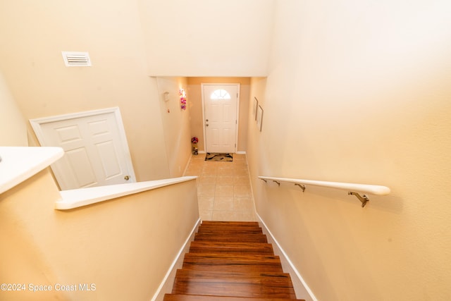 stairway with hardwood / wood-style floors