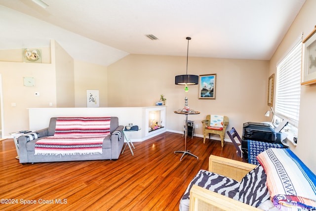 living room with hardwood / wood-style flooring and vaulted ceiling