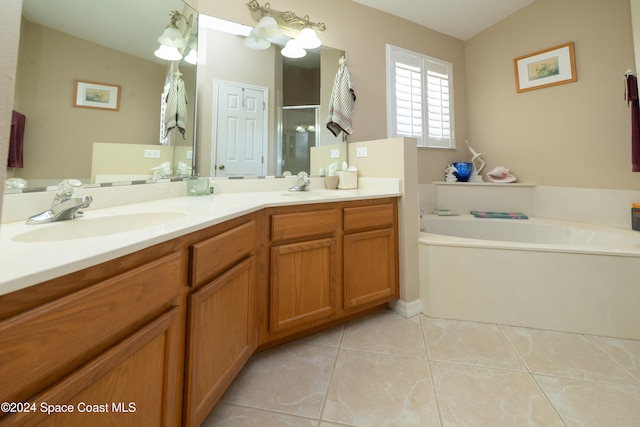 bathroom with tile patterned flooring, shower with separate bathtub, and vanity