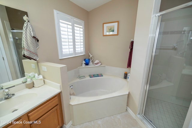 bathroom with independent shower and bath, vanity, and tile patterned floors