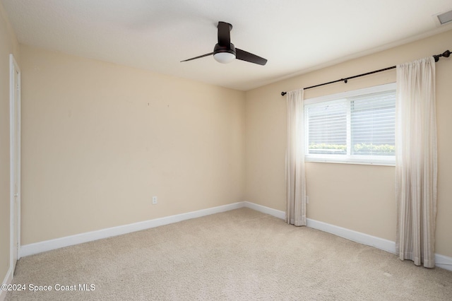 carpeted empty room featuring ceiling fan