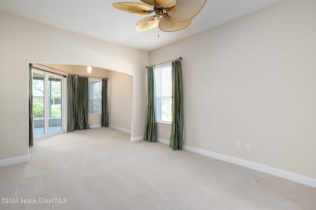 unfurnished room featuring light colored carpet and ceiling fan