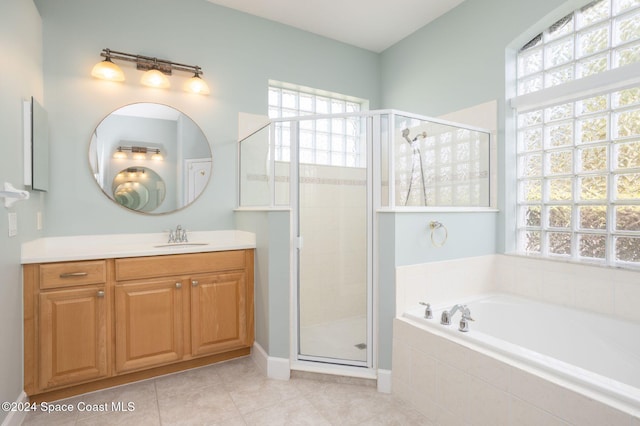 bathroom with vanity, tile patterned floors, and shower with separate bathtub