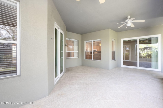 interior space with a wealth of natural light and ceiling fan