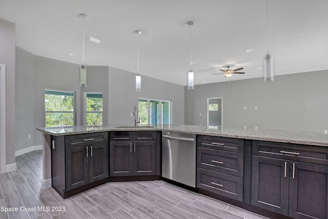 kitchen featuring stainless steel dishwasher, a healthy amount of sunlight, sink, and decorative light fixtures