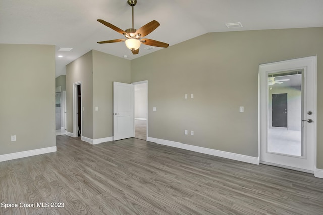 unfurnished room featuring ceiling fan, light hardwood / wood-style flooring, and vaulted ceiling