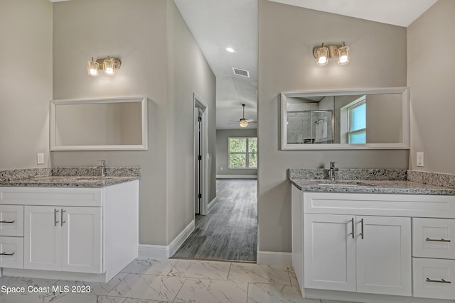 bathroom featuring vanity, ceiling fan, and a shower