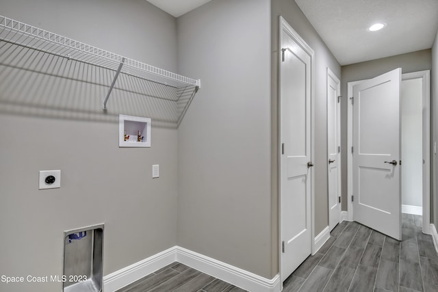 clothes washing area with hardwood / wood-style floors, hookup for a washing machine, and electric dryer hookup