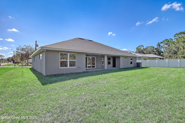 rear view of house with a lawn