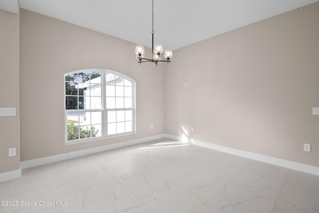 unfurnished room featuring an inviting chandelier