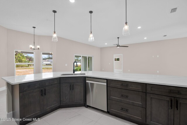 kitchen with sink, stainless steel dishwasher, light stone counters, and decorative light fixtures