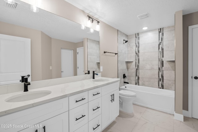 full bathroom with vanity, toilet, tiled shower / bath combo, and a textured ceiling