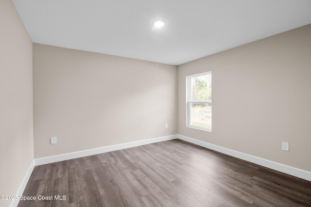 empty room with hardwood / wood-style flooring