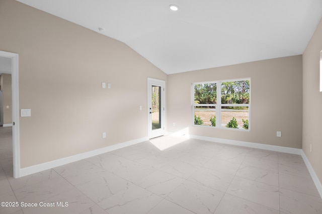 spare room featuring vaulted ceiling