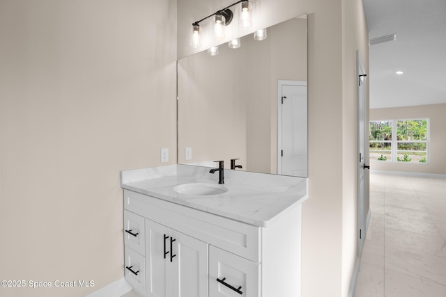 bathroom with vanity and vaulted ceiling