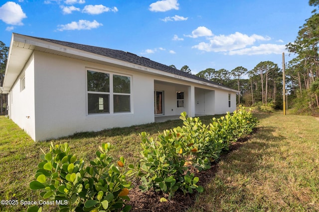 rear view of property with a lawn