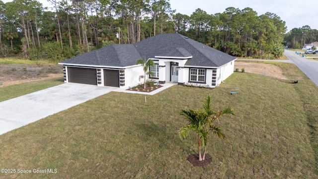 view of front of property featuring a garage and a front lawn