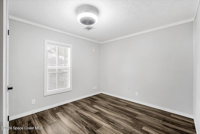 unfurnished room featuring dark wood-type flooring, a textured ceiling, and ornamental molding