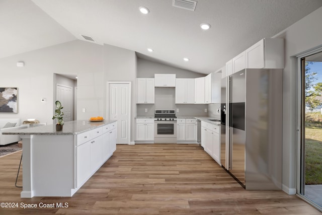 kitchen featuring appliances with stainless steel finishes, light wood-type flooring, white cabinetry, and a healthy amount of sunlight