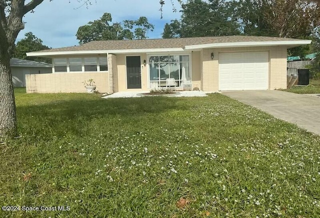 single story home featuring a garage and a front lawn