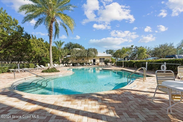 view of swimming pool with a patio