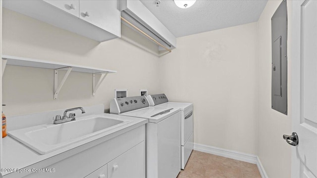 washroom featuring electric panel, cabinets, a textured ceiling, sink, and washing machine and clothes dryer