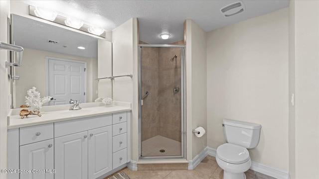 bathroom with tile patterned flooring, a textured ceiling, toilet, and a shower with door