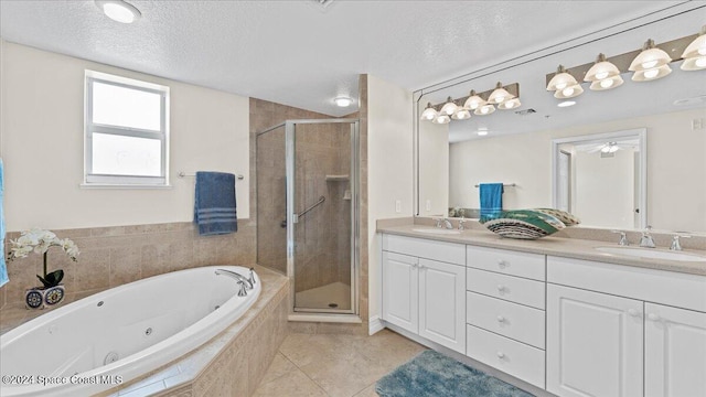 bathroom with vanity, a textured ceiling, tile patterned floors, and separate shower and tub