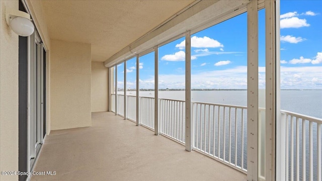 unfurnished sunroom with a water view