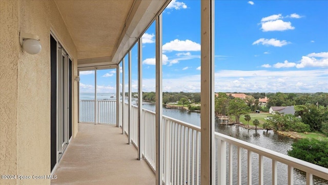 unfurnished sunroom with a water view