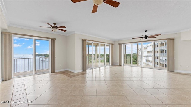 tiled empty room with ornamental molding, a water view, and ceiling fan