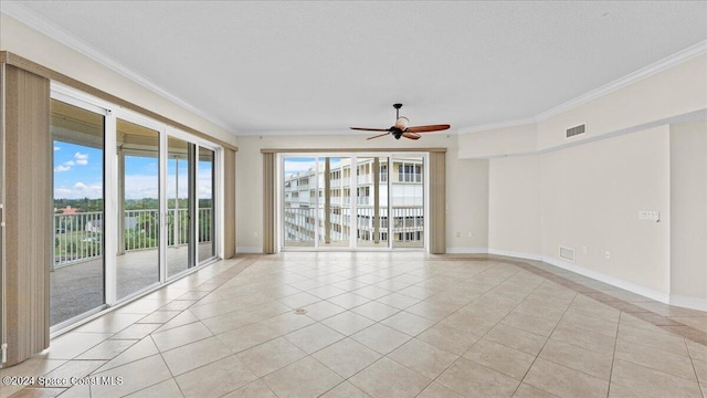 tiled empty room with a textured ceiling, a wealth of natural light, ceiling fan, and crown molding